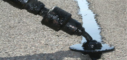 Photo of cracked asphalt being filled